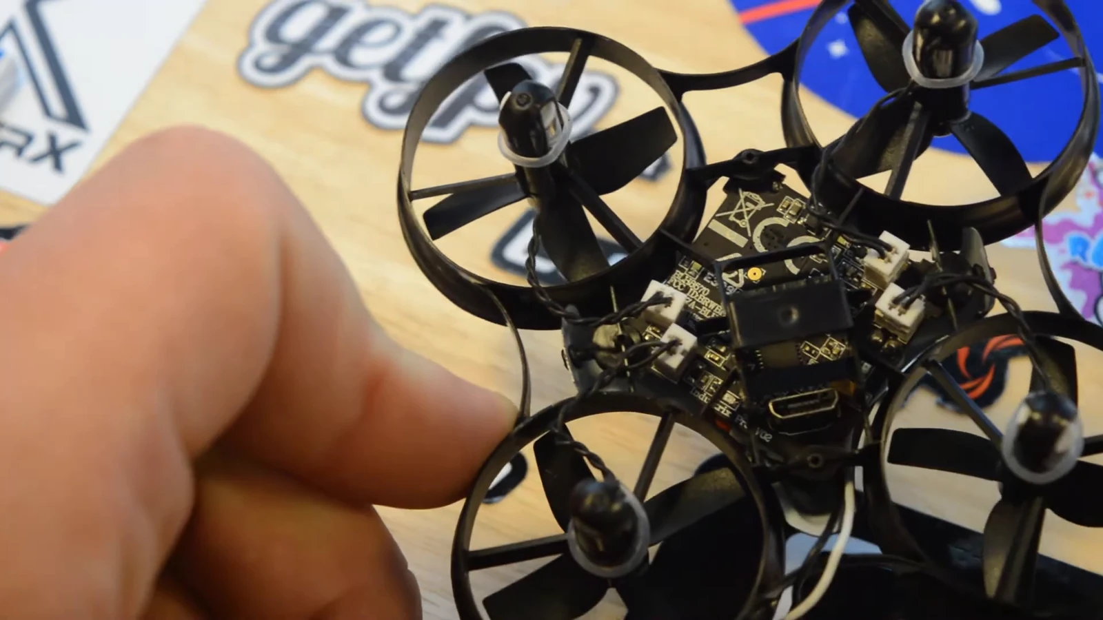 A small ducted quadcopter with its circuit board exposed