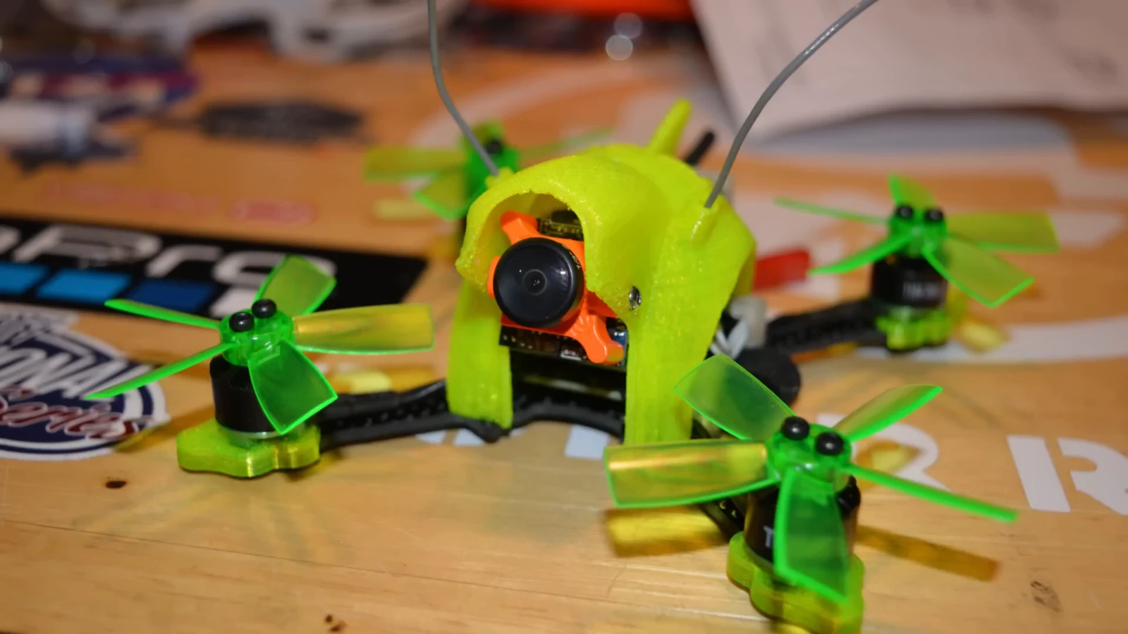 A green micro quadcopter on the workbench