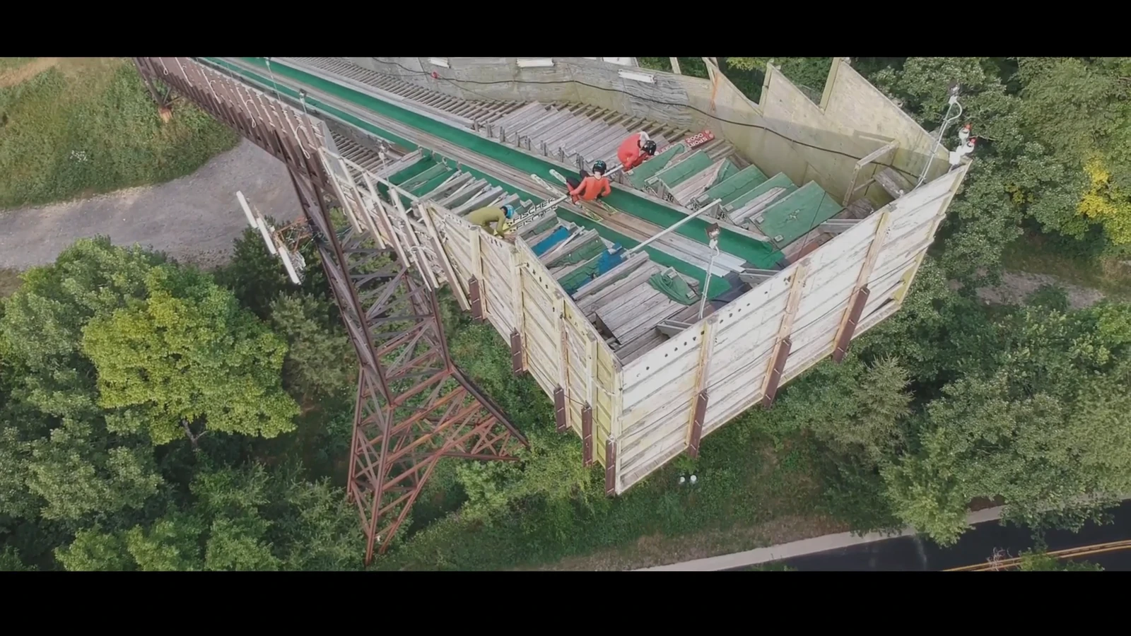 An FPV aerial view beside a ski-jump structure